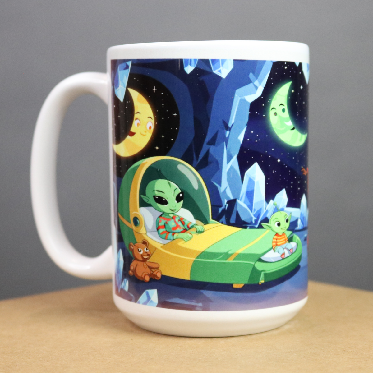 Mug with a design of an alien in bed on a starry night background