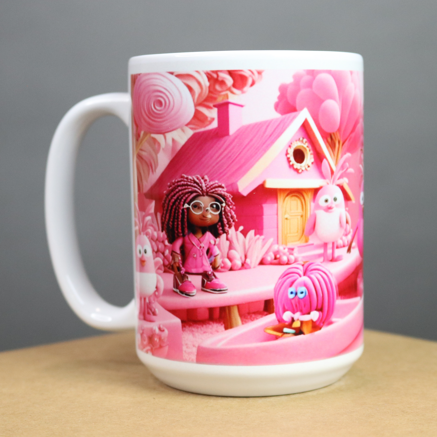 Pink mug with a pink design of characters and a pink house on a pink background